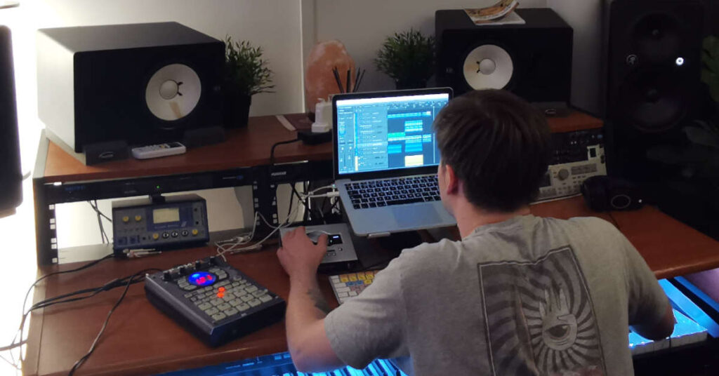 An audio engineer mixing in a studio